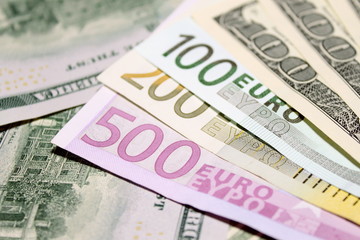 Background of euro and dollar bills. Shallow focus.