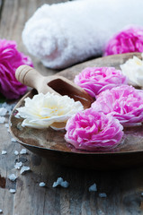 Fototapeta na wymiar Concept of spa treatment with roses and salt