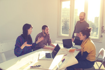 Young group of people discussing business plans.