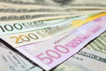 Background of euro and dollar bills. Shallow focus.