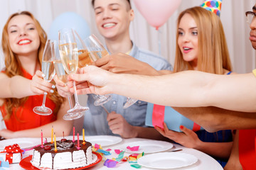 Young people celebrating a birthday sitting at the table