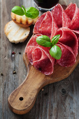 Delicious salami with basil and wine