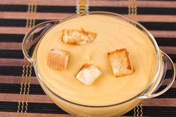 Pea soup with crouton close up.