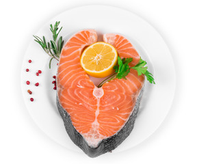 Raw salmon steak with lemon.