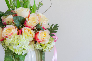 Beautiful Fake Flowers in Whie pot on wood table