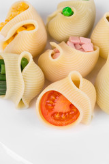 Pasta shells stuffed with vegetables and sausage.