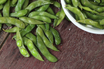 Edamame soy beans on wood background.