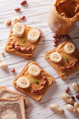 Kids sandwiches with peanut cream and banana. top view