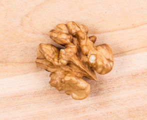 Walnut kernel on wooden background. 