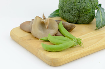 sugar pea, Jew's Ear Mushroom broccoli on cutting board isolated