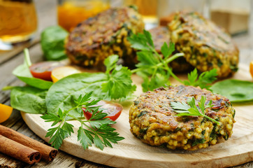 spicy vegan curry burgers with millet, chickpeas and herbs