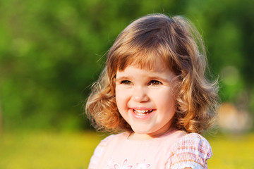  Beautiful little girl in a park