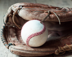 Old and worn used leather baseball sport glove over aged