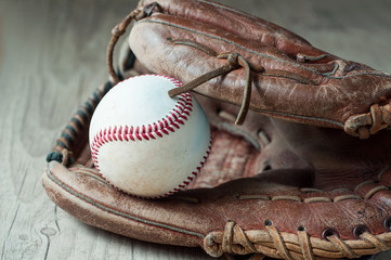 Old and worn used leather baseball sport glove over aged