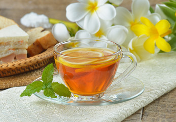cups of tea with mint on wooden table
