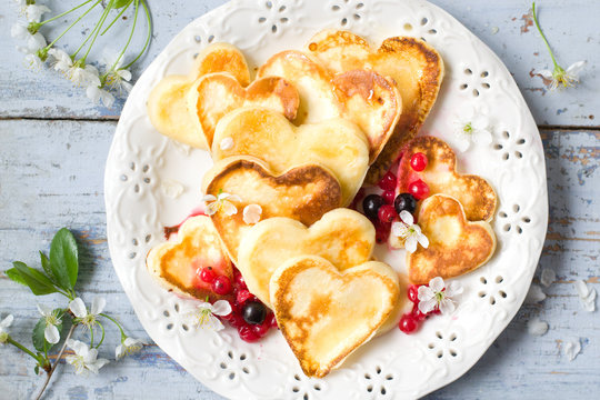 Heart shaped pancakes with currant and honey