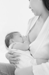 Obraz na płótnie Canvas Black and white shot of asian mother breastfeeding her baby