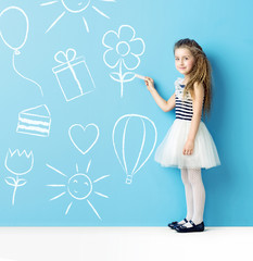 Little girl making chalk drawings