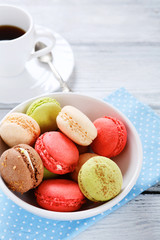 Macaroon in a white bowl with coffee