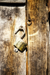 Old padlock on wooden door
