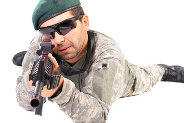 Closeup of young soldier or sniper aiming with a rifle