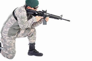 Young soldier or sniper aiming with a rifle
