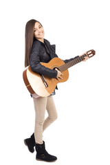 Full length portrait of happy teenage girl playing guitar