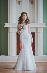 Fototapeta premium The young bride costs with a bunch of flowers 2645.