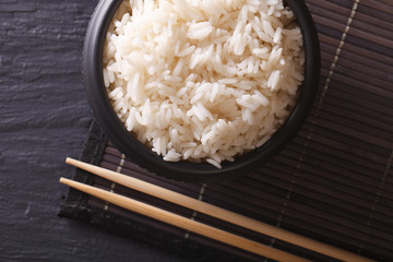 White rice in a black bowl. horiozntal top view
