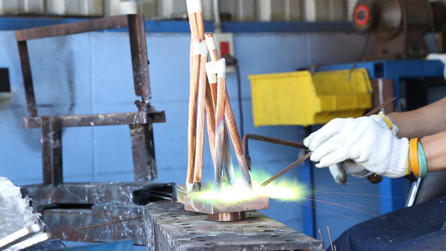 Copper welding by worker