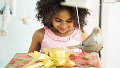 Adorable girl opening the birthday gift © konradbak