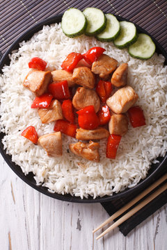 Rice with chicken pieces close-up. vertical top view
