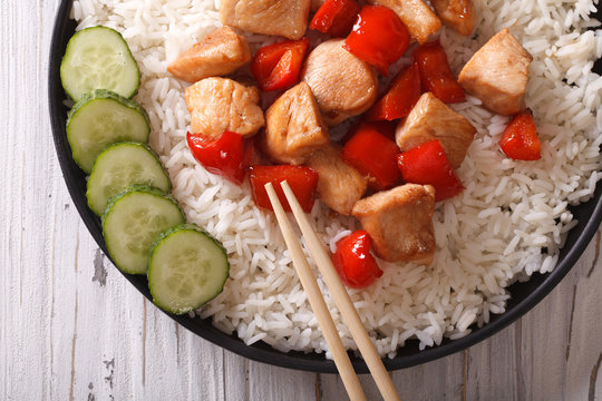 Asian food: rice with chicken close-up. horizontal top view 
