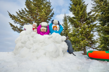 Group of happy kids play snowballs game together