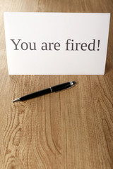 Message You're Fired on wooden background