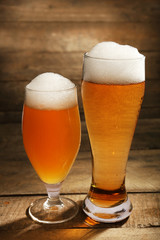 Glasses of beer on wooden background