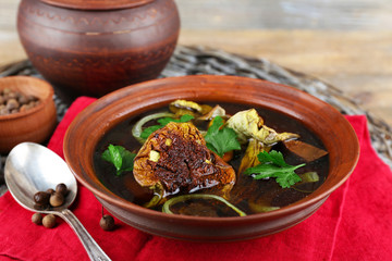 Mushroom soup on wicker man and color napkin, closeup