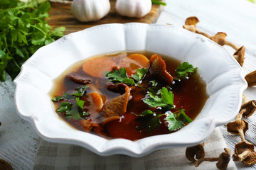 Mushroom soup on wooden table, closeup