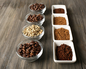 Coffee beans in saucers on wooden background