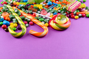 Colorful candies on purple background