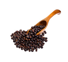 Dried Juniper berries on the wooden spoon.