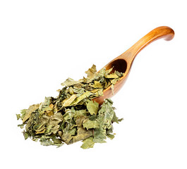 Dry mulberry leaves on the wooden spoon.