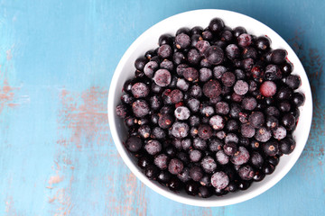 Blackberry in bowl on wooden background
