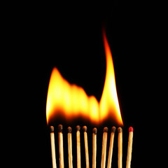 Burning matches on dark gray background