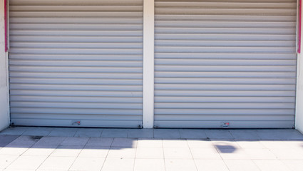 Double doors garage with wide long driveway.