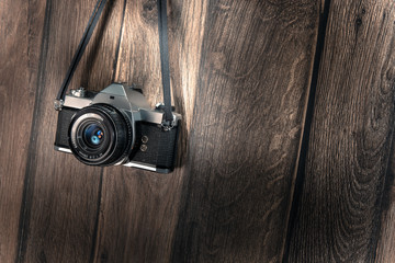 Film camera on vintage wooden planks hanging