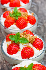 homemade desert with cream chopped cookies and fresh strawberry
