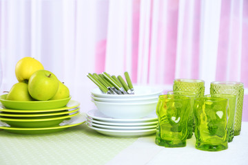 Colorful table settings and tulip flowers in vase on table, on light background