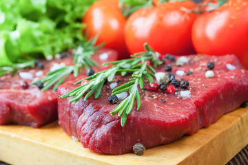Raw beef steak with vegetables and spices 