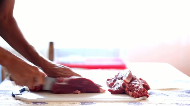 HD 1080 closeup: chef cutting beef steak onto slices